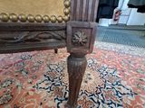 a chair that is sitting on a rug on the floor