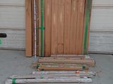 several pieces of wood are stacked on top of each other in front of a garage door