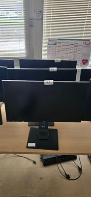 a desk with a computer monitor and a keyboard on it