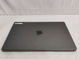 a black apple laptop sitting on a white surface