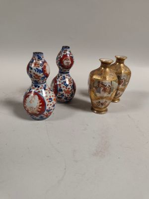 two vases and a vase on a table with a white background