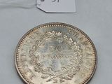 a close up of a coin on a table with a price tag
