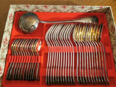 a red tray with silverware in it on a table