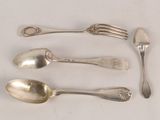 five spoons and a fork on a white surface