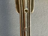 a silver spoon and fork sitting on a table