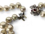 pearl necklace with a diamond clasp and a pearl necklace with a diamond clasp