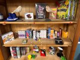 a wooden bookcase with many different games on it