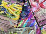 a lot of pokemon cards that are on the table