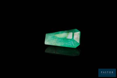a green emerald stone on a black background