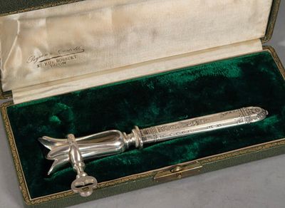 a silver knife in a green box on a table