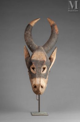 a close up of a sculpture of a cow ' s head on a stand