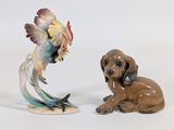 two figurines of a dog and a bird on a white background