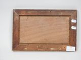 an old picture frame with a piece of wood on top of it