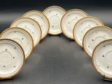 six white and gold china plates with gold rims