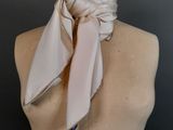 beige silk neck scarf on a mannequin torso