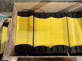 four batteries in a cardboard box on a table