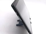 a tablet computer sitting on a stand on a white surface