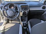 the interior of a small car with a steering wheel and dashboard