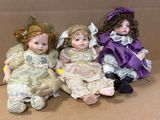 three dolls that are sitting in a cardboard box
