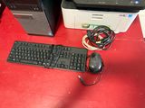 a keyboard, mouse, and printer on a red table