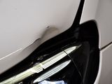 a close up of a car ' s headlight with a sticker on it