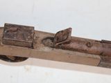 a wooden object with a metal handle on a white surface