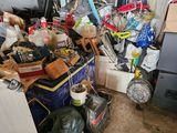 a pile of clutter in a room with a lot of junk