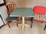 two chairs and a table in a small room