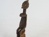 an image of a wooden statue of a person on a white background