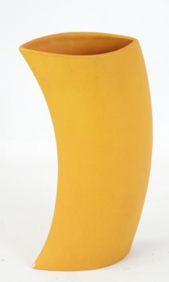 a yellow vase with a curved design on it