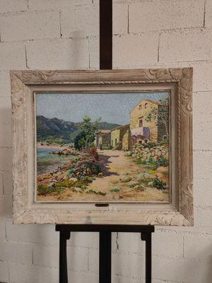 un tableau posé sur un chevalet devant un mur de briques