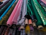 a lot of different colors of fabric on a rack