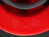 a close up of a red fire hydrant with a black handle
