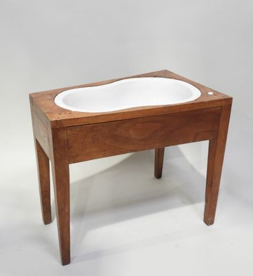 a small wooden table with a white bowl on it