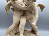 an image of a statue of a boy and a girl holding each other