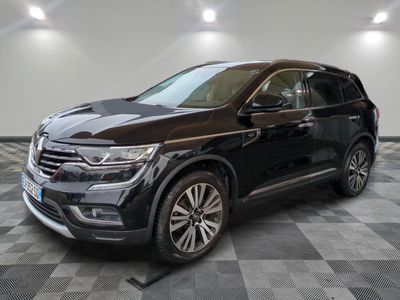 un 4x4 noir garé sur un sol en damier dans un garage