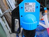 a blue water pump with a hose attached to it