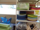 a room with a lot of different colored items on the shelves