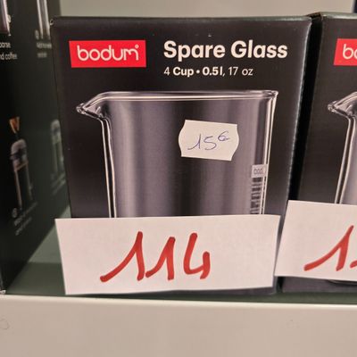 two boxes of glass are on a shelf in a store