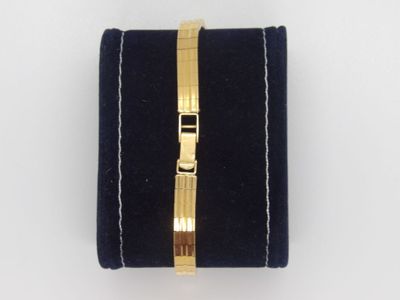 a close up of a black velvet case with a gold clasp