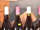 several bottles of wine are lined up in a row on a table
