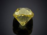 a yellow diamond on a black surface