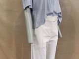the mannequin is wearing a blue shirt and white pants
