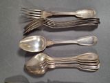 a lot of silver spoons and spoons on a table