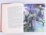 an open book with a picture of elephants in the water