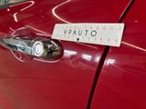 a sticker on the door handle of a red car