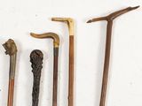 four different types of walking canes on a white surface