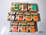 six boxes of coffee sit on a table next to each other