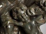 a bronze statue of a woman holding a child