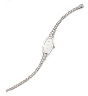a close up of a wrist watch with a chain on a white background